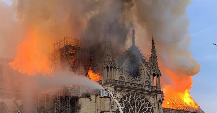 notre dame in flames paris 696x365